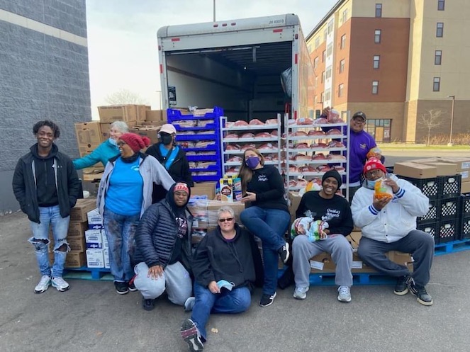 Onika's Angels showing teamwork as they unpack a truckload of goods to distribute to those in need. 