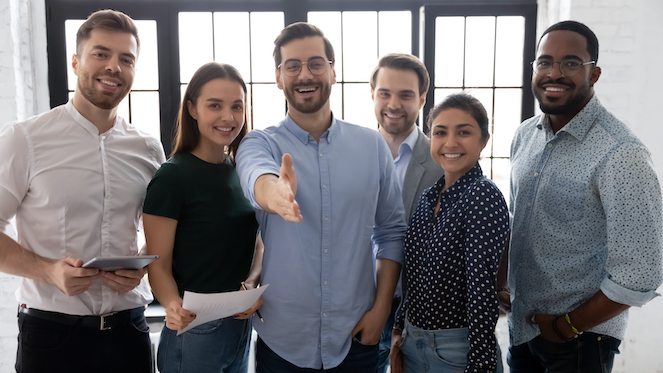 Group of employee assistants greeting someone.