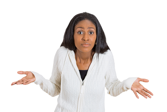 A woman showing body language with raised shoulders and eyebrows during a conflict. 