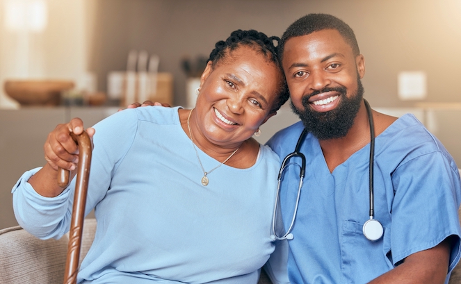 Nurse, senior black woman and doctor or caregiver hugging for support, love and gratitude in nursing home. Smile, healthcare worker and happy African elderly person with a cane for a disability