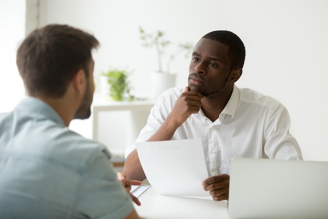 Manager intently listening to his employee, helping him feel seen, heard, and valued