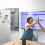 Teammates high-fiving at work