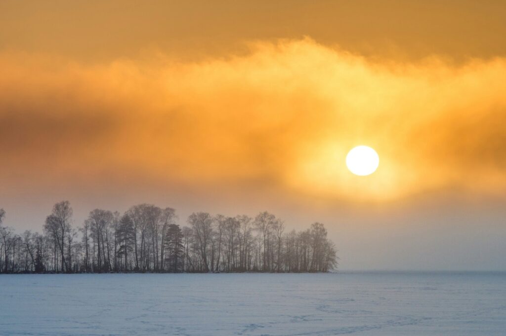Beautiful bright sun shining through the clouds in limited daylight