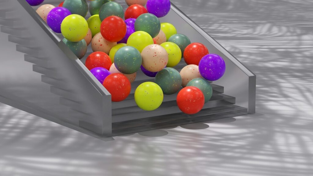 A bunch of colorful balls falling down a set of stairs. 