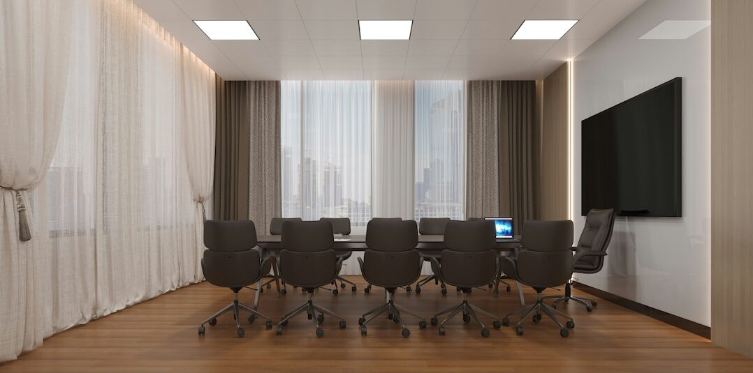 Executive meeting space sitting empty with lots of open chairs