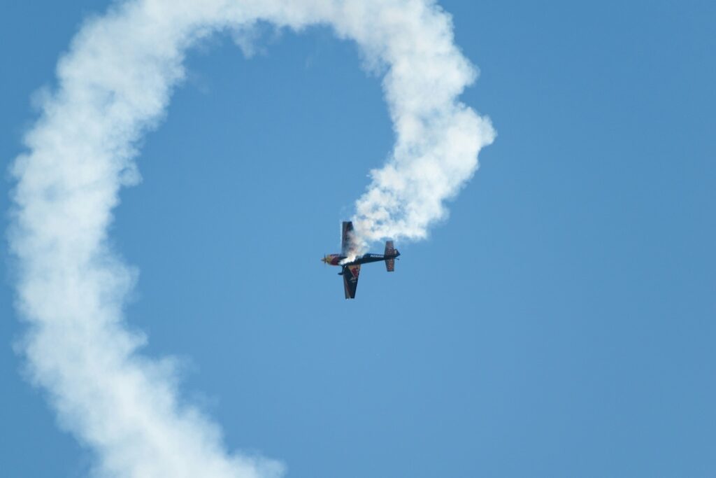 An airplane in a downward spiral with smoke and exhaust coming out of it. 