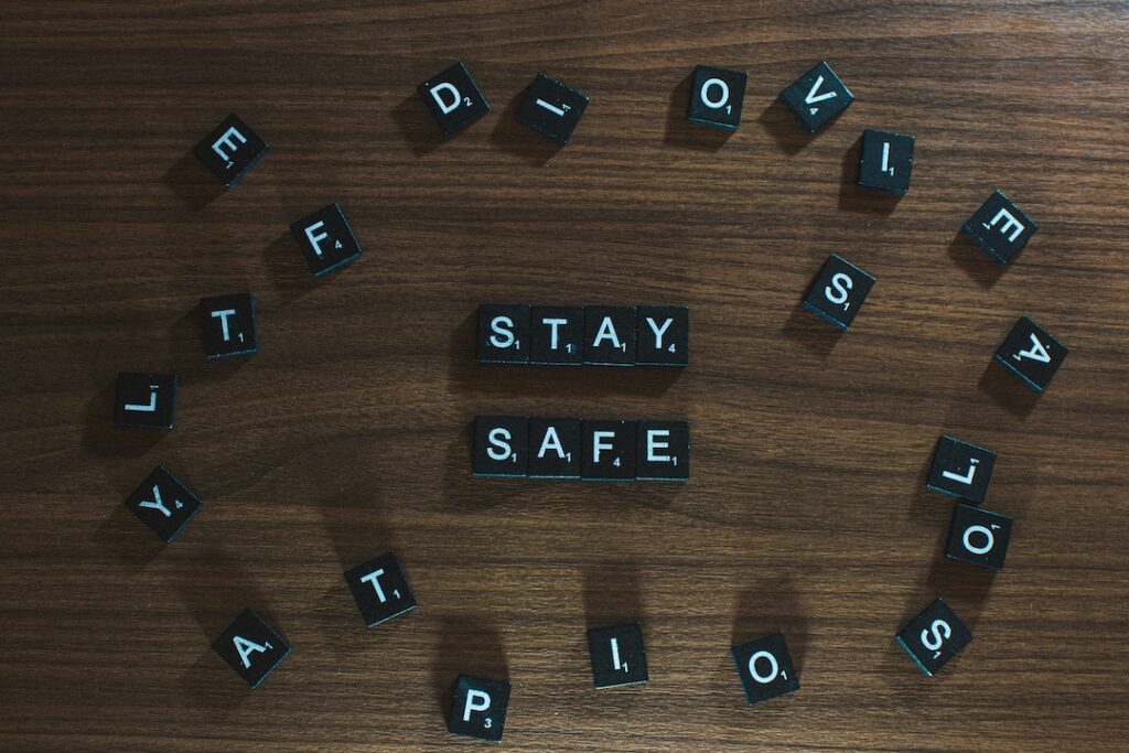 Black scrabble letters spelling the words stay safe to show that its in our DNA to avoid risk. 