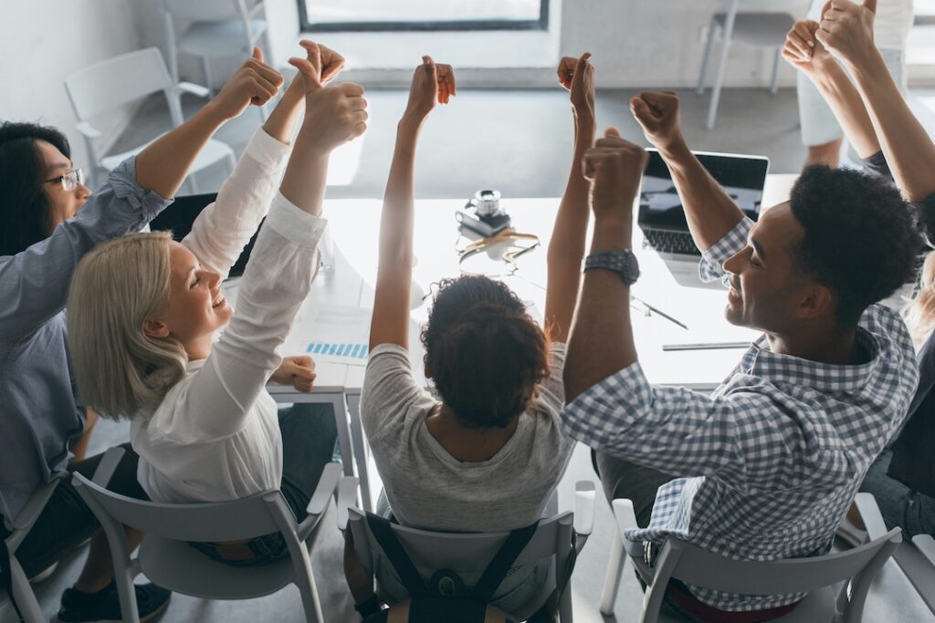 High-performing team celebrating together in the office. 